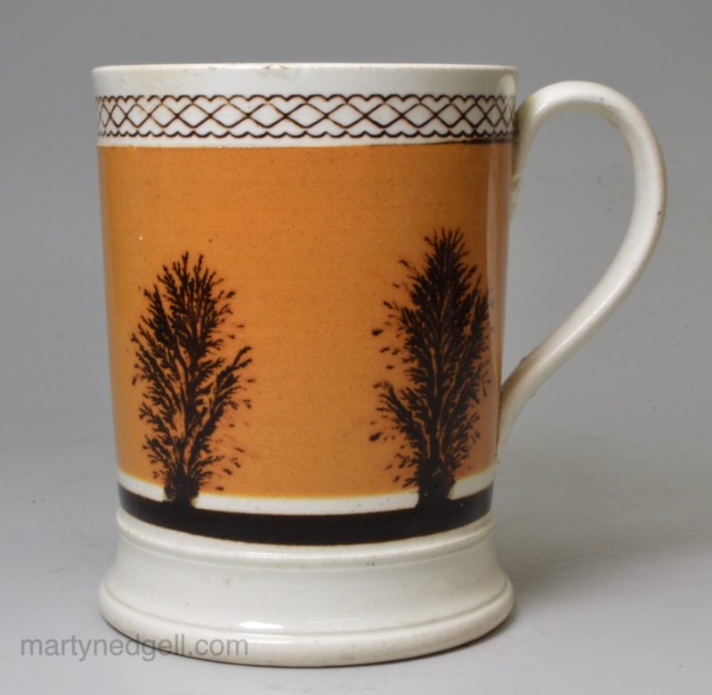 Mochaware pottery mug decorated with a dendritic design on tan coloured slip, circa 1830