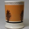 Mochaware pottery mug decorated with a dendritic design on tan coloured slip, circa 1830