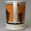 Mochaware pottery mug decorated with a dendritic design on tan coloured slip, circa 1830