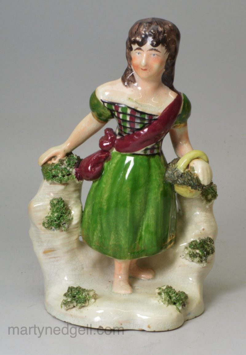 Pearlware pottery figure of a Scottish girl, circa 1830, probably Scottish Pottery