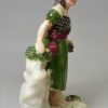 Pearlware pottery figure of a Scottish girl, circa 1830, probably Scottish Pottery