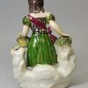 Pearlware pottery figure of a Scottish girl, circa 1830, probably Scottish Pottery