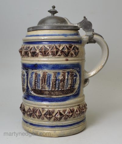 Westerwald saltglaze stoneware tankard decorated with moulded town views, circa 1680