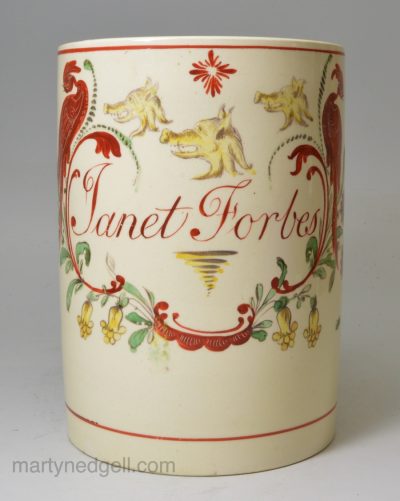 Creamware pottery tankard decorated in enamels over the glaze with the name 'Janet Forbes' within a family crest, circa 1790