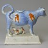 Pearlware pottery cow creamer with sponge decoration under the glaze, circa 1820