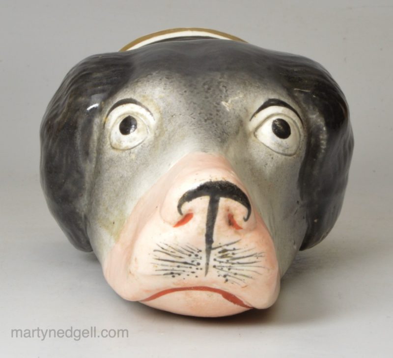 Staffordshire pottery hounds head stirrup cup, circa 1850