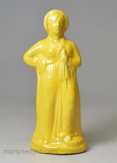 Canary yellow pottery figure of a woman and umbrella circa 1820