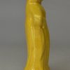 Canary yellow pottery figure of a woman and umbrella circa 1820