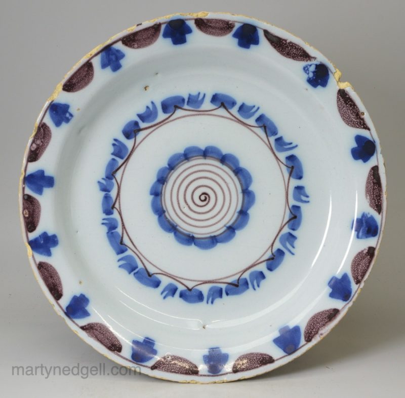 London delft pancake plate decorated in blue and manganese, circa 1740