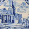 Dutch Delft tile decorated with two monks approaching a church with a bird nesting on the roof, circa 1750