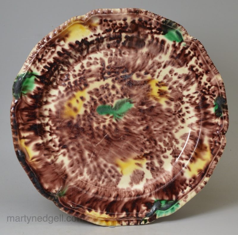 Creamware pottery plated decorated with Whieldon type colours under the glaze, circa 1770