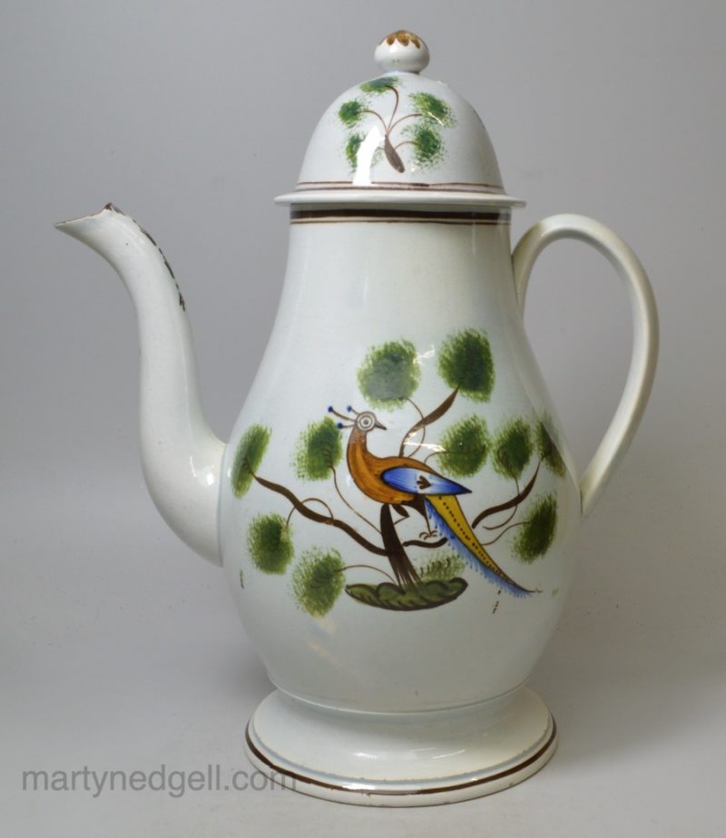 Pearlware pottery coffee pot decorated with pea fowl in colours under the glaze, circa 1820