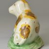 Small creamware pottery model of a dog decorated with colours under the glaze, circa 1790