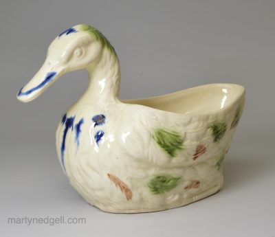Creamware pottery duck sauce boat decorated with coloured splashes under the glaze, circa 1780