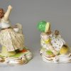 Pair of derby porcelain figures of girls with their pets, circa 1820