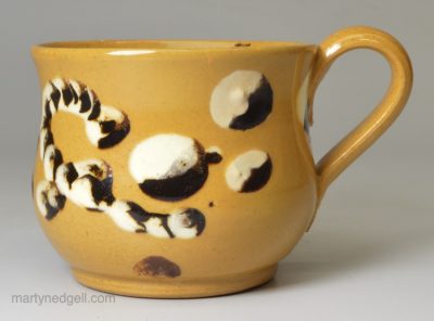 Small yellow bodied cup decorated with mocha slip, circa 1840