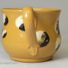 Small yellow bodied cup decorated with mocha slip, circa 1840