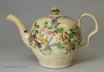 Creamware pottery teapot moulded with flowers and decorated with colours under the glaze, circa 1770 William Greatbatch Pottery Staffordshire