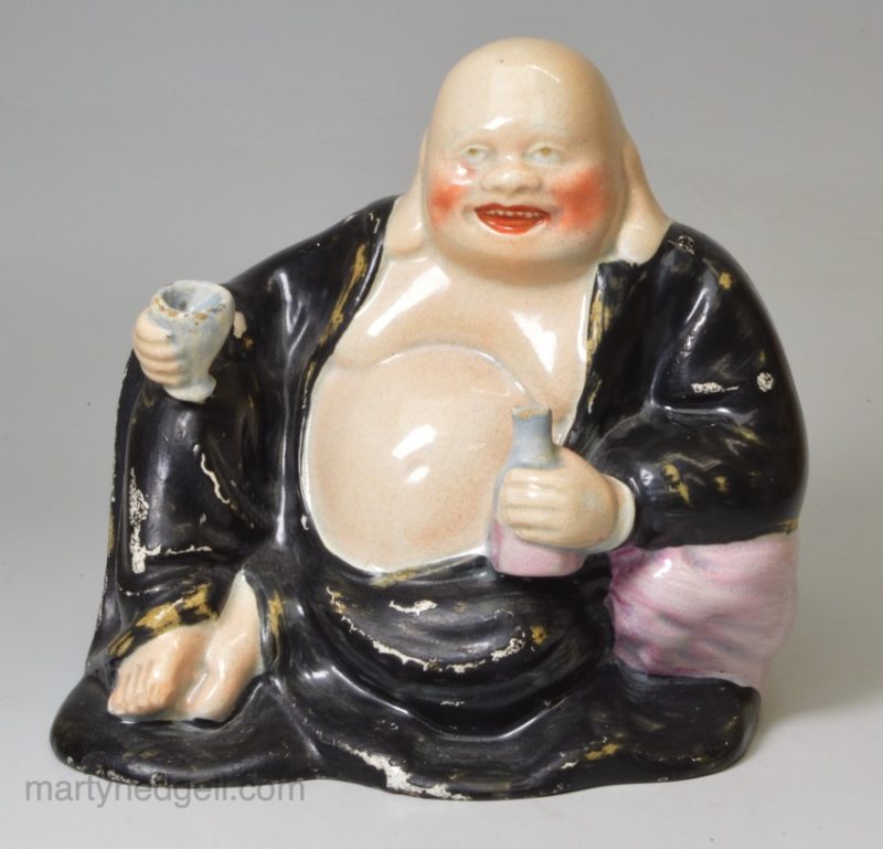 Staffordshire pearlware pottery figure of a Hotei after Chinese original, circa 1820
