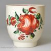 Creamware pottery coffee cup and saucer decorated with enamels over the glaze, circa 1780, probably Leeds Pottery