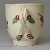 Creamware pottery coffee cup and saucer decorated with enamels over the glaze, circa 1780, probably Leeds Pottery