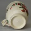 Creamware pottery coffee cup and saucer decorated with enamels over the glaze, circa 1780, probably Leeds Pottery