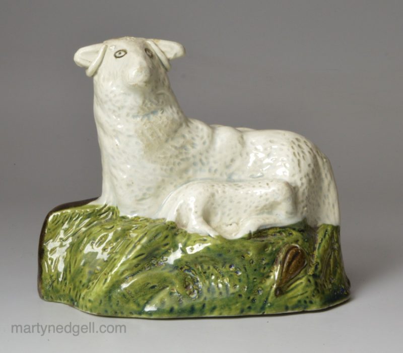 Pearlware pottery sheep and lamb decorated with colours under the glaze, circa 1800
