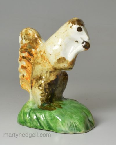 Pearlware pottery figure of a squirrel decorated with colours under the glaze, circa 1800