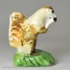 Pearlware pottery figure of a squirrel decorated with colours under the glaze, circa 1800