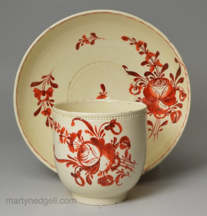 Creamware coffee cup and saucer decorated with enamels over the glaze, circa 1780