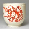 Creamware coffee cup and saucer decorated with enamels over the glaze, circa 1780
