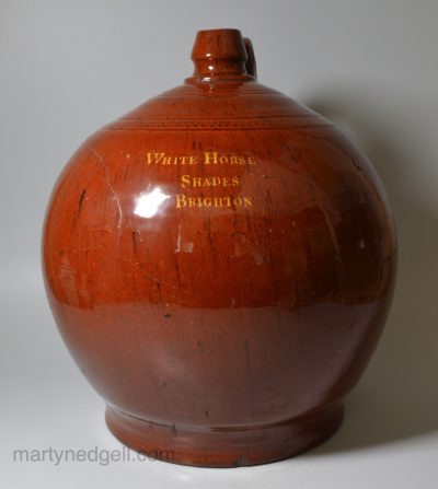 Large Sussex redware flagon 'WHITE HORSE SHADES BRIGHTON' inlaid in yellow slip, circa 1800
