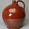 Large Sussex redware flagon 'WHITE HORSE SHADES BRIGHTON' inlaid in yellow slip, circa 1800