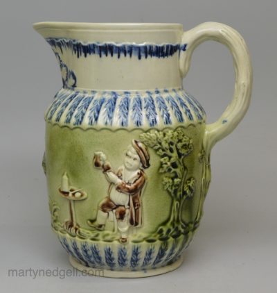 Pearlware pottery jug moulded with the Vicar, Sexton and Clerk decorated with colours under the glaze, circa 1800