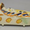 Large prattware pottery sleeping child in a cradle, circa 1820