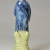 Pearlware pottery figure of a man playing the hardy curdy decorated with colours under the glaze, circa 1800