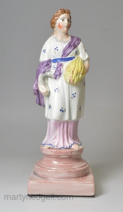 Pearlware pottery figure of Summer decorated with overglaze enamels, circa 1820