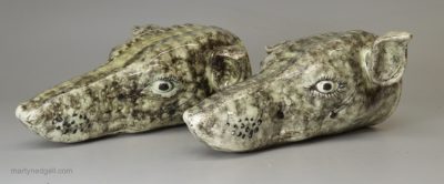 Pair of pearlware pottery greyhound head stirrup cups decorated with Whieldon type colours under the glaze, circa 1800