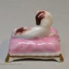 Staffordshire porcelain spaniel on a cushion, circa 1830