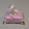 Staffordshire porcelain spaniel on a cushion, circa 1830