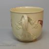 Creamware pottery coffee cup and saucer painted with red enamels over the glaze, circa 1770, probably Leeds Pottery