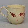 Creamware pottery coffee cup and saucer painted with red enamels over the glaze, circa 1770, probably Leeds Pottery