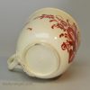 Creamware pottery coffee cup and saucer painted with red enamels over the glaze, circa 1770, probably Leeds Pottery
