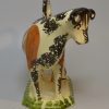 Creamware pottery cow creamer decorated with colours under the glaze, circa 1820