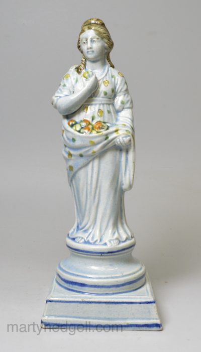 Perarlware pottery figure of Summer decorated with colours under the glaze, circa 1820