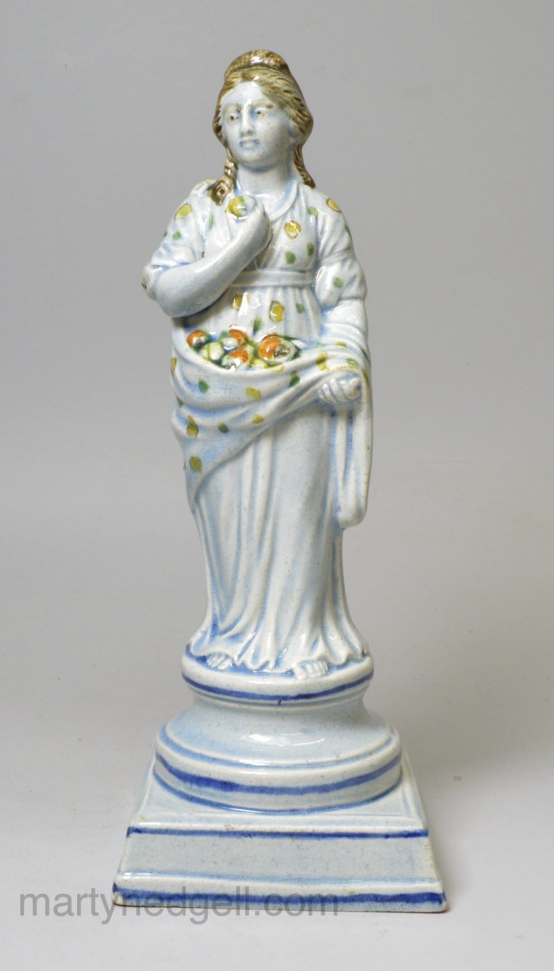 Perarlware pottery figure of Summer decorated with colours under the glaze, circa 1820