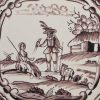 Liverpool delft biblical tile painted in manganese with a man with hawk, circa 1750