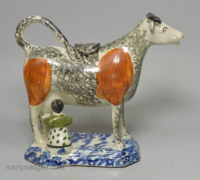 Pearlware pottery cow creamer decorated with colours and sponging under the glaze, circa 1820