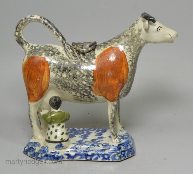 Pearlware pottery cow creamer decorated with colours and sponging under the glaze, circa 1820