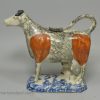 Pearlware pottery cow creamer decorated with colours and sponging under the glaze, circa 1820